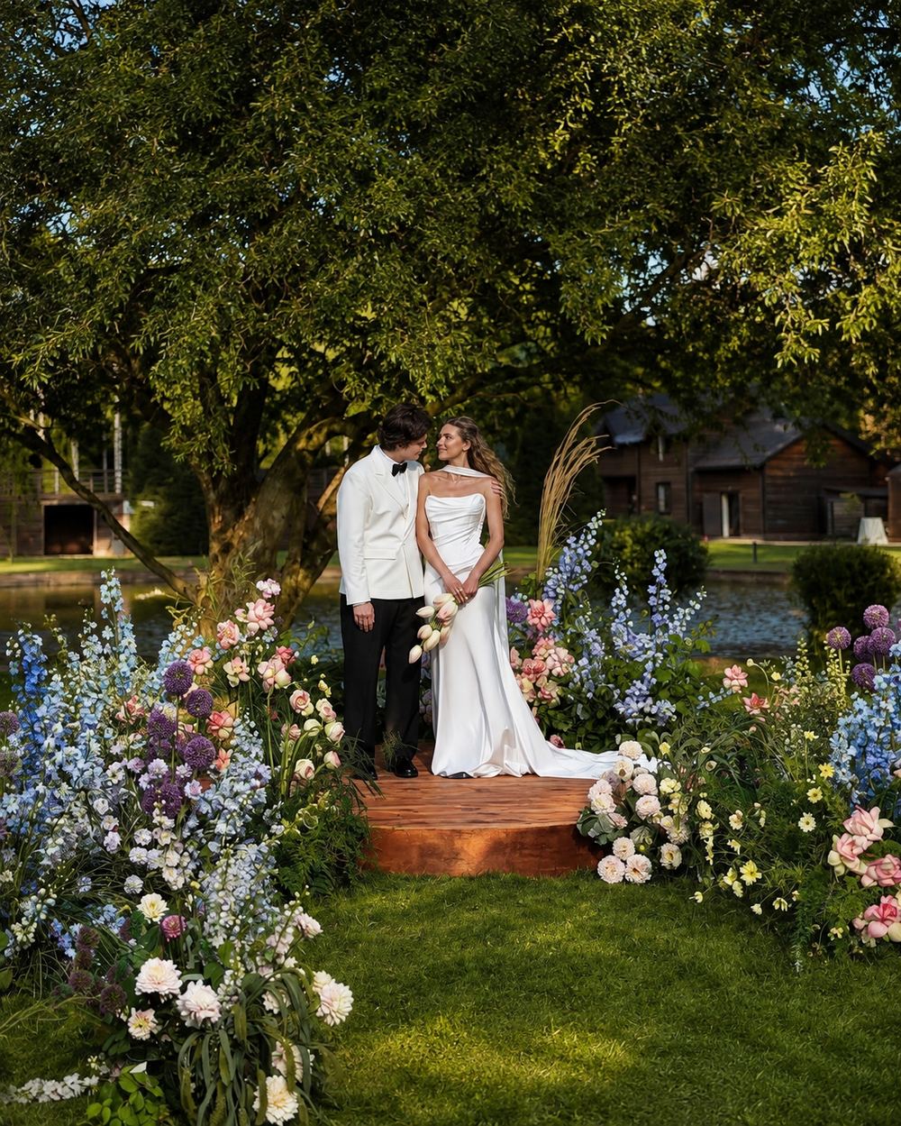 Intimate garden ceremony surrounded by lush floral borders